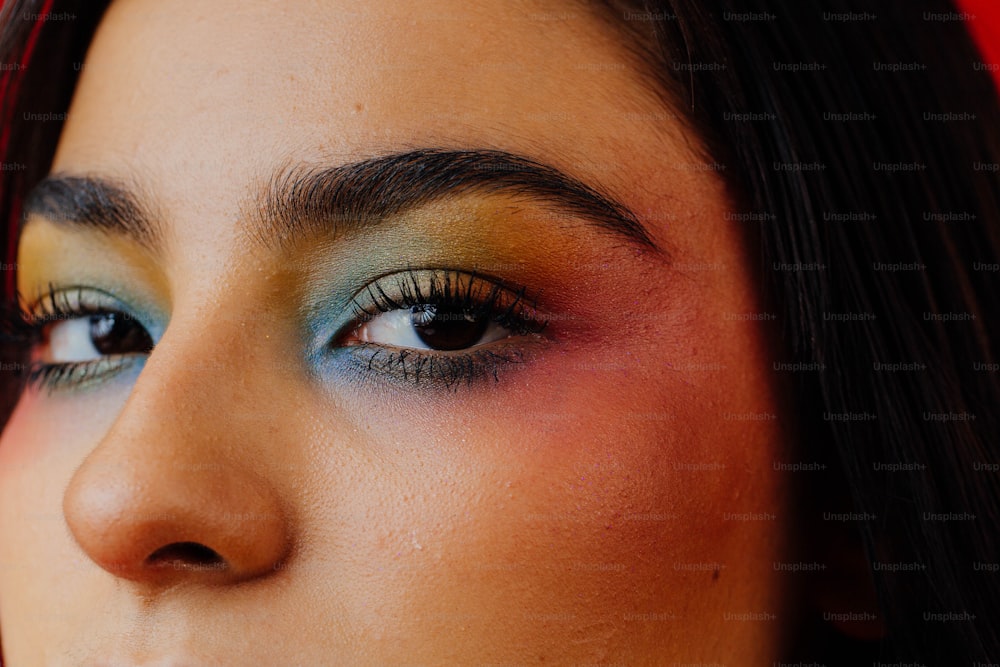 a close up of a woman's face with bright makeup