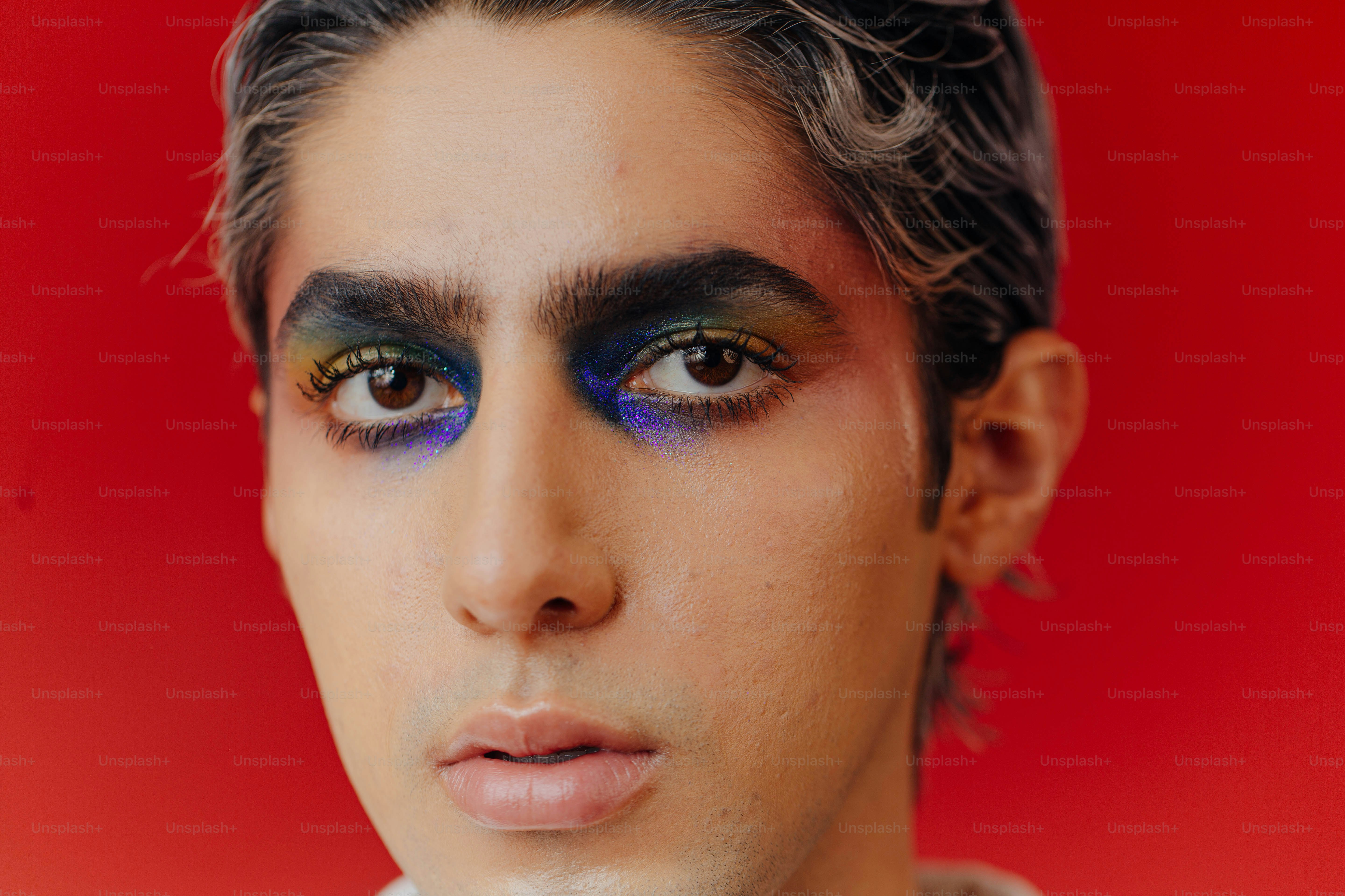 A man with black and blue makeup on his face photo Portrait Image on