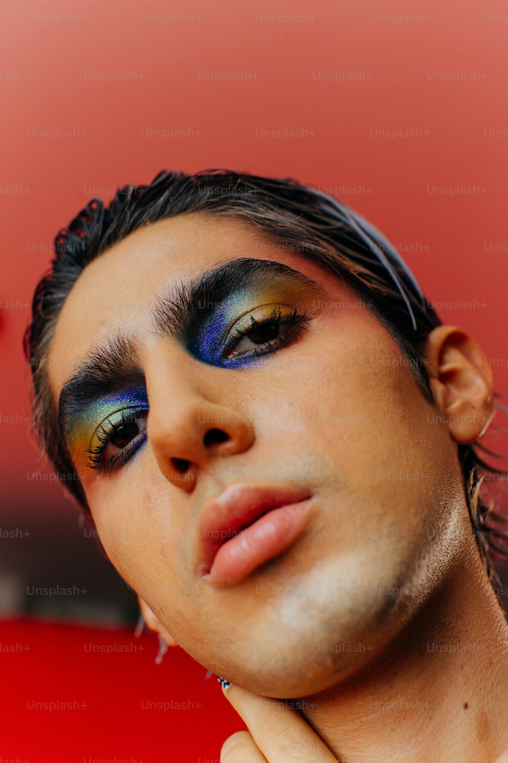 a man with a blue and yellow make up on his face
