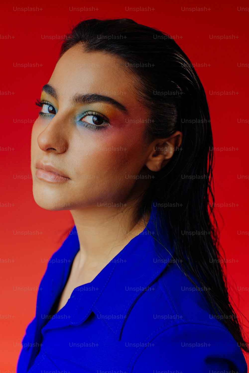 a woman with a blue shirt and a red background