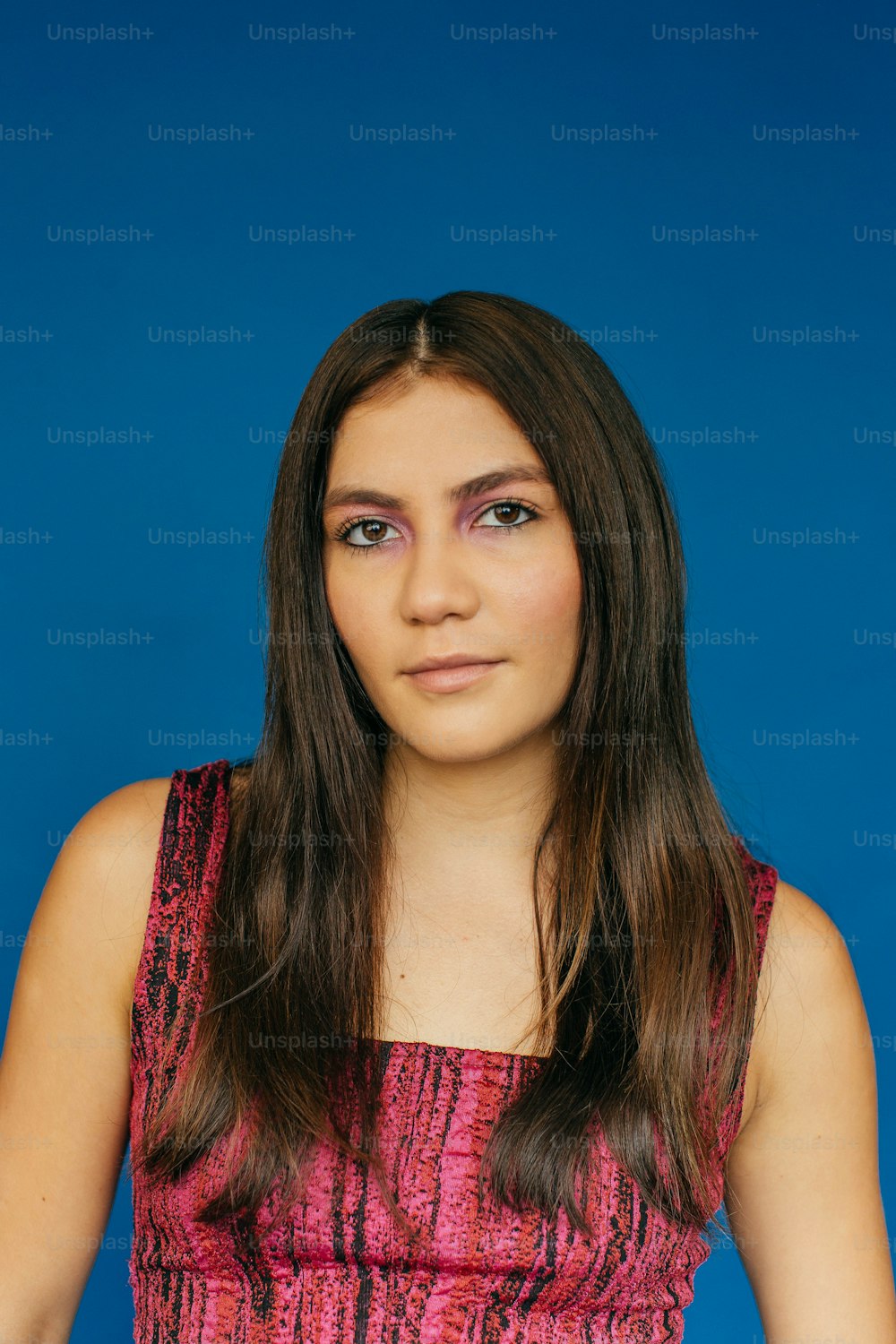 a woman in a pink dress posing for a picture