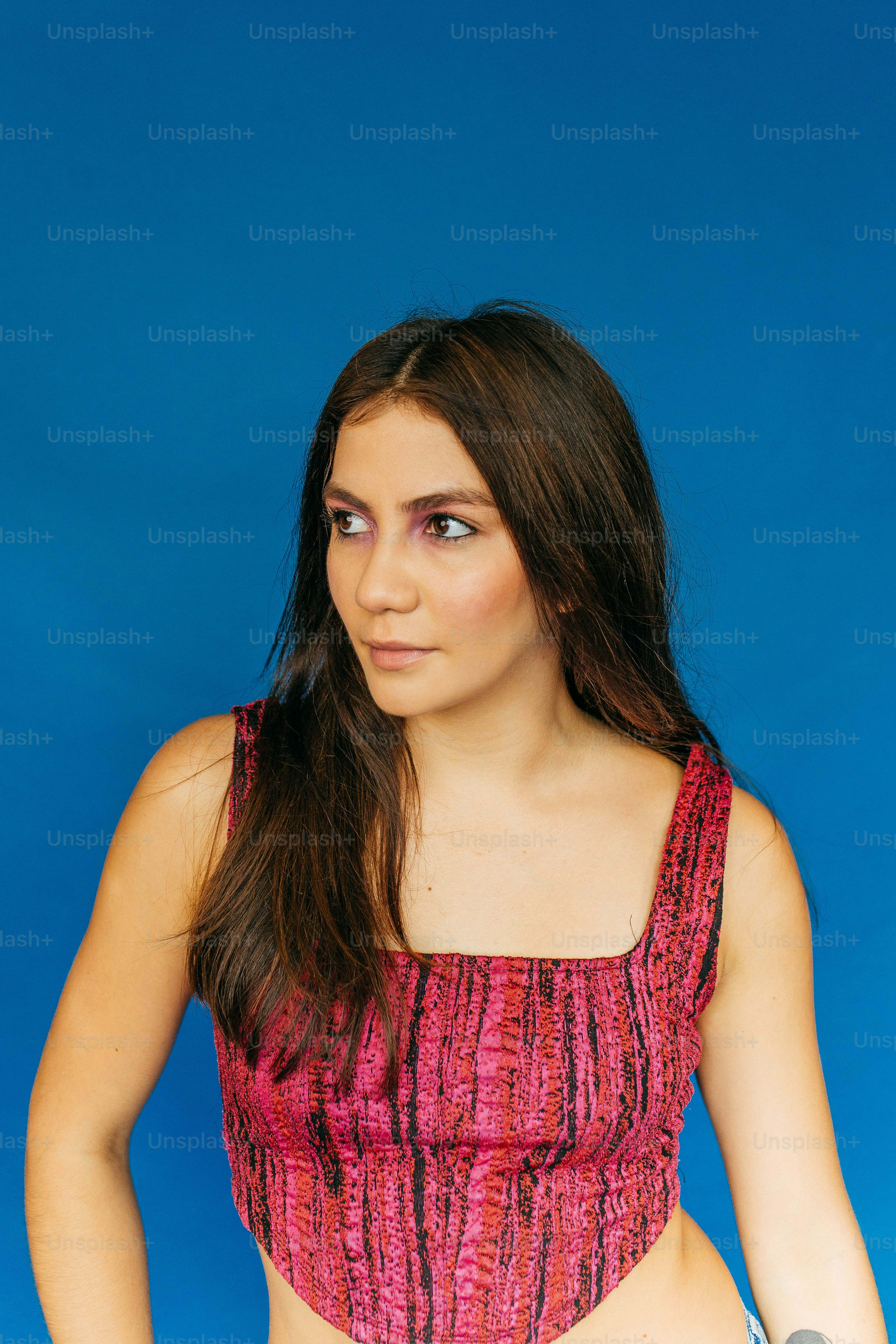 a woman in a pink top holding a tennis racquet