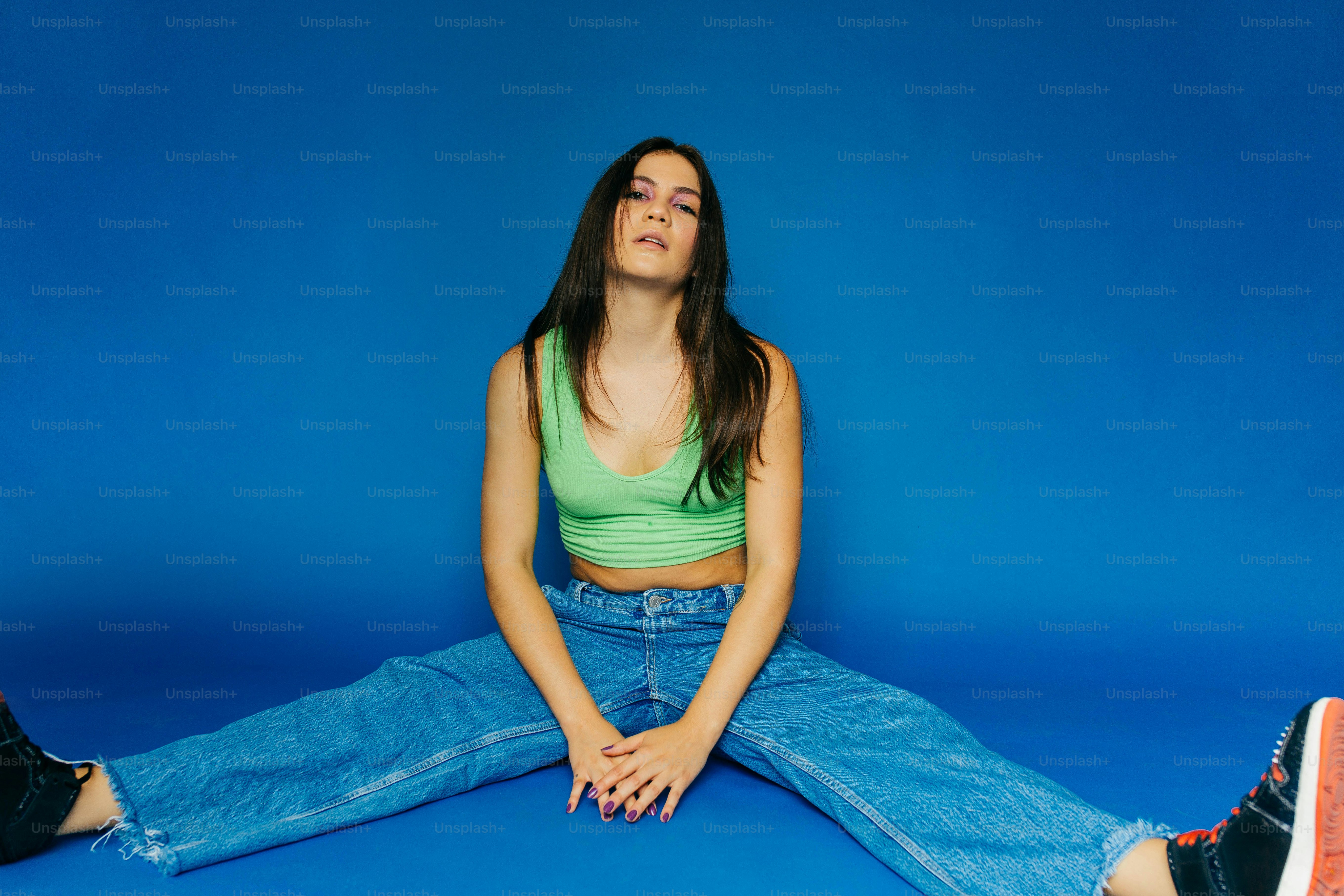 A woman sitting on the floor with her eyes closed photo – Fashion Image ...