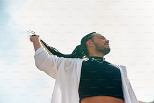 a man with dreadlocks and a black shirt