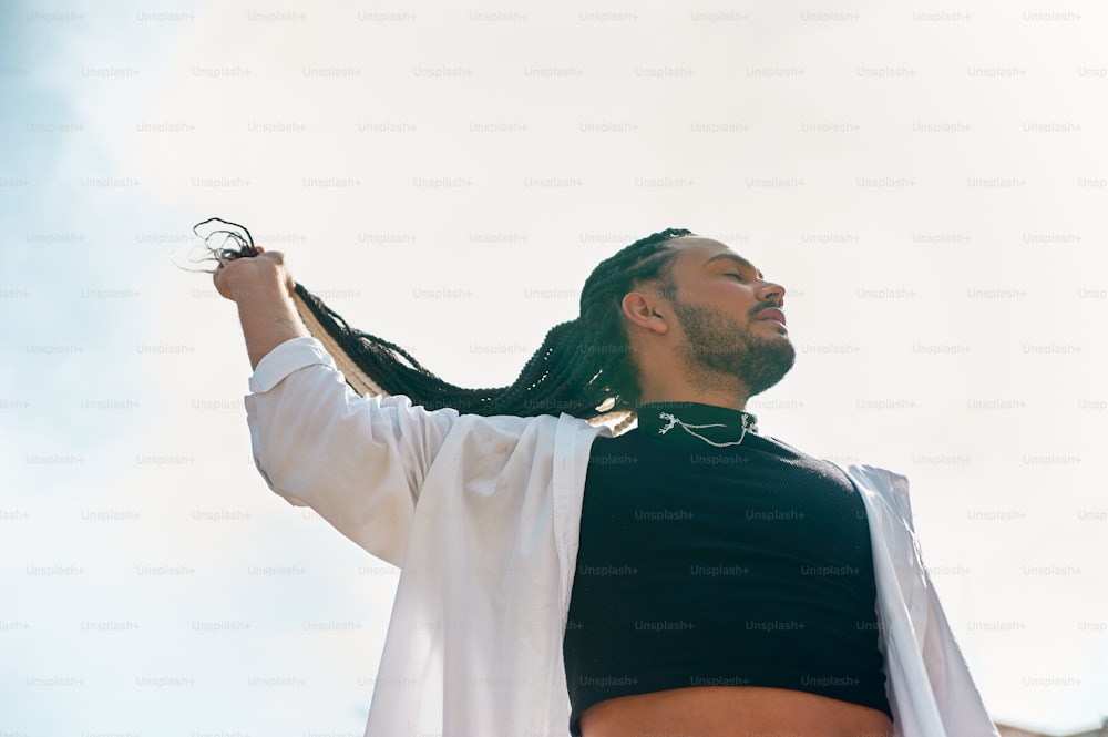 a man with dreadlocks and a black shirt