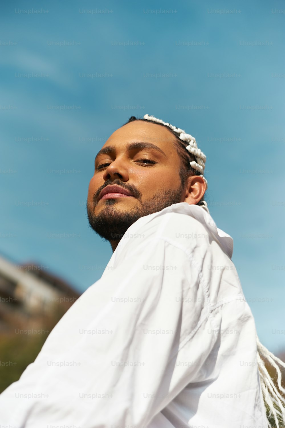 a man wearing a white shirt and a headband