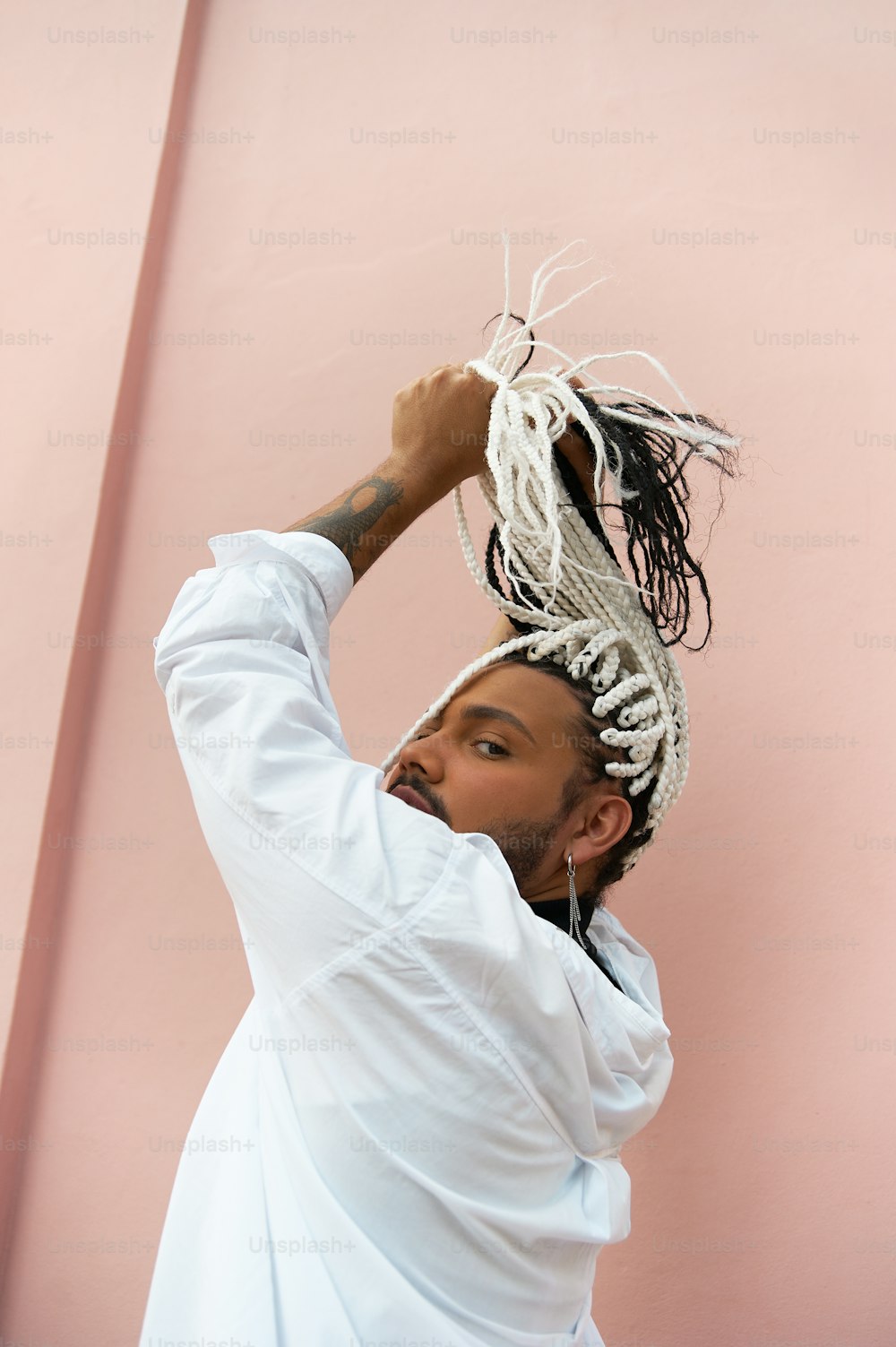 a man with dreadlocks and a white shirt