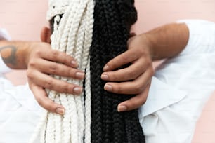 a person with their hands on a black and white scarf