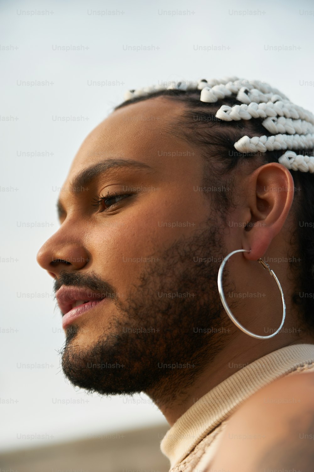 a close up of a person wearing a pair of hoop earrings