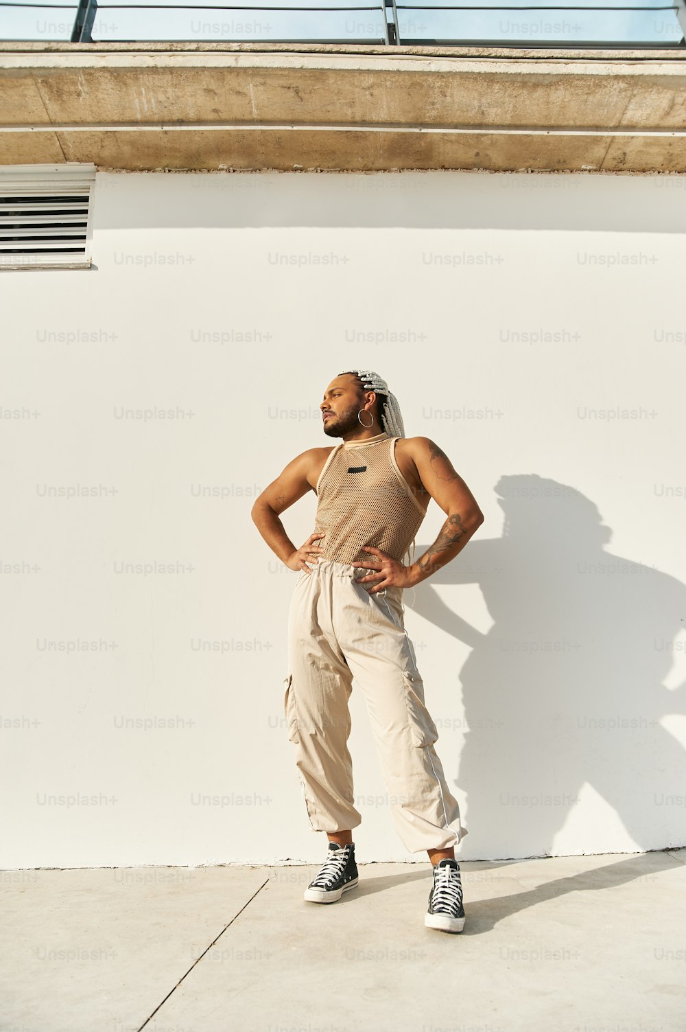a man standing in front of a white wall