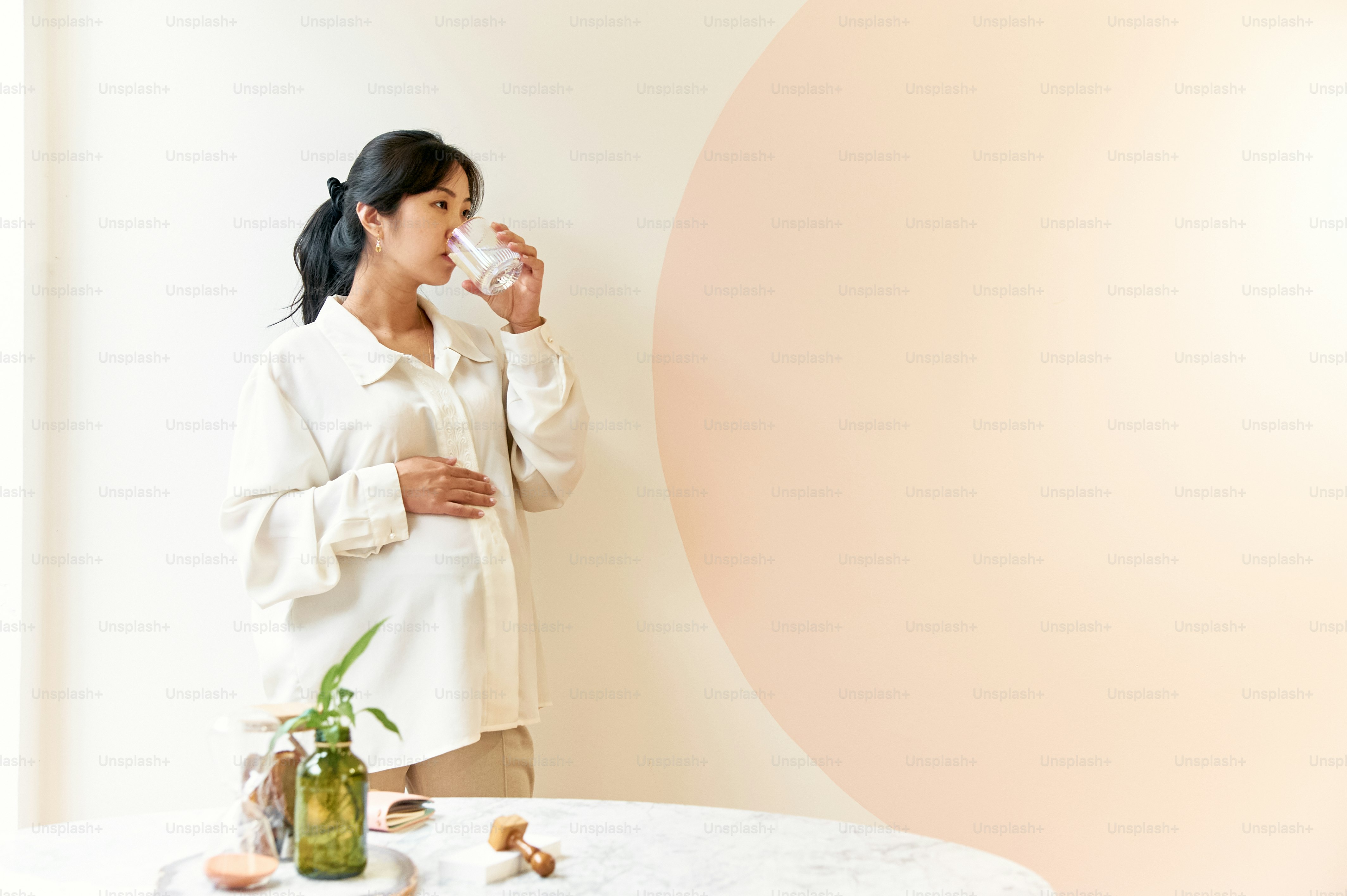 a woman drinking a glass of water
