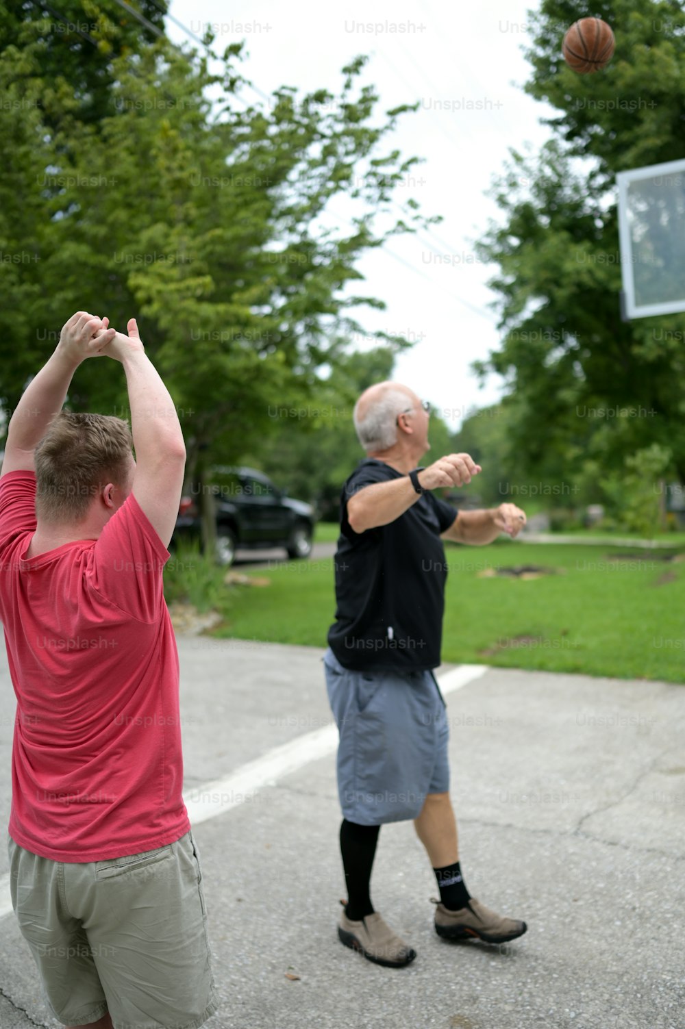 a couple of men playing a game of basketball