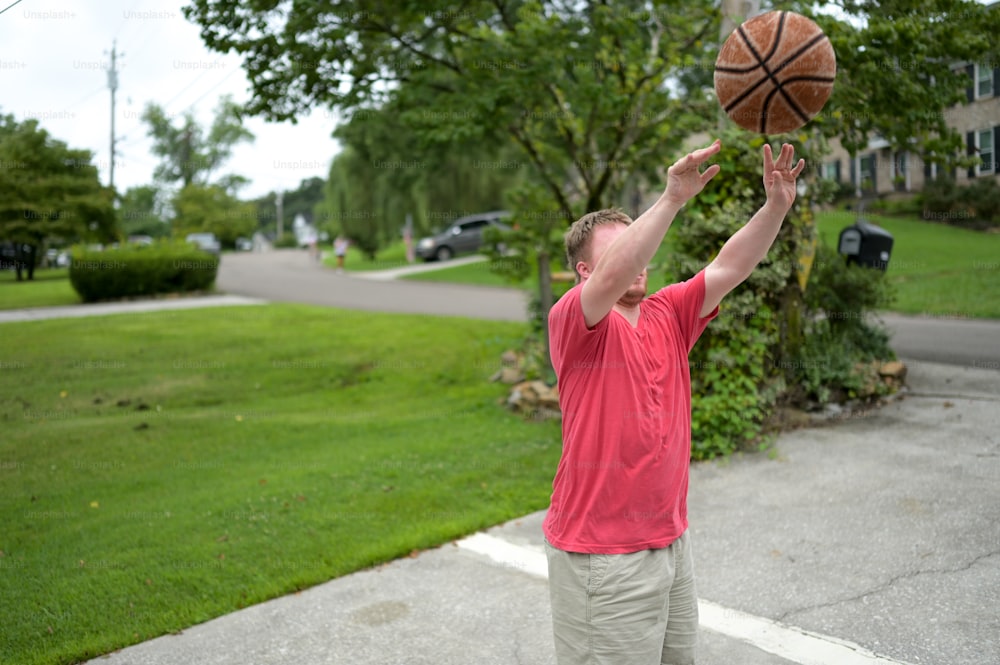 a man holding a basketball up in the air