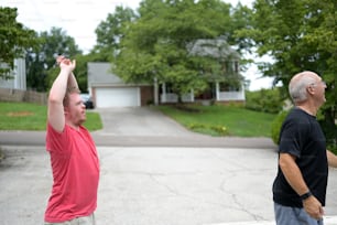 a couple of men standing on top of a street