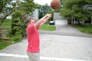 a man is throwing a basketball in the air