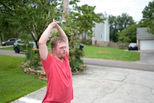 a man in a red shirt holding a frisbee