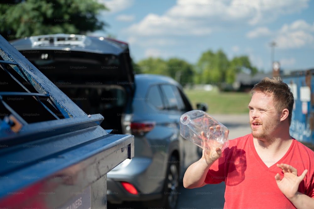 a man standing next to a car holding a bubble