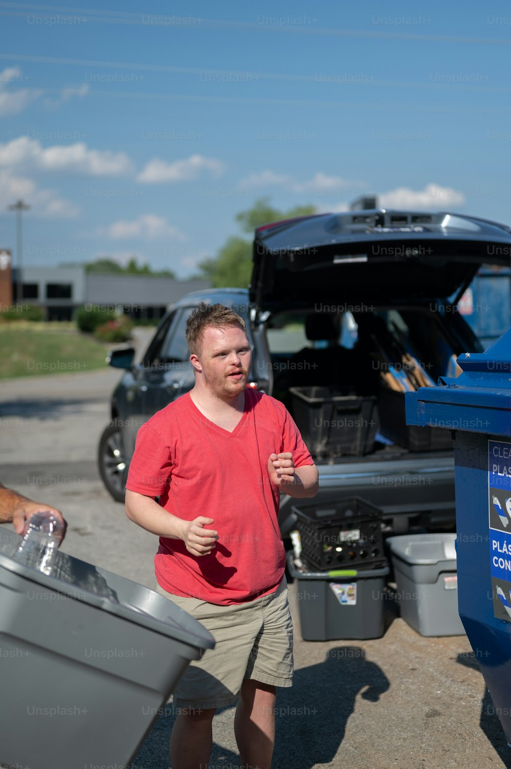 a man standing next to a truck with a cooler