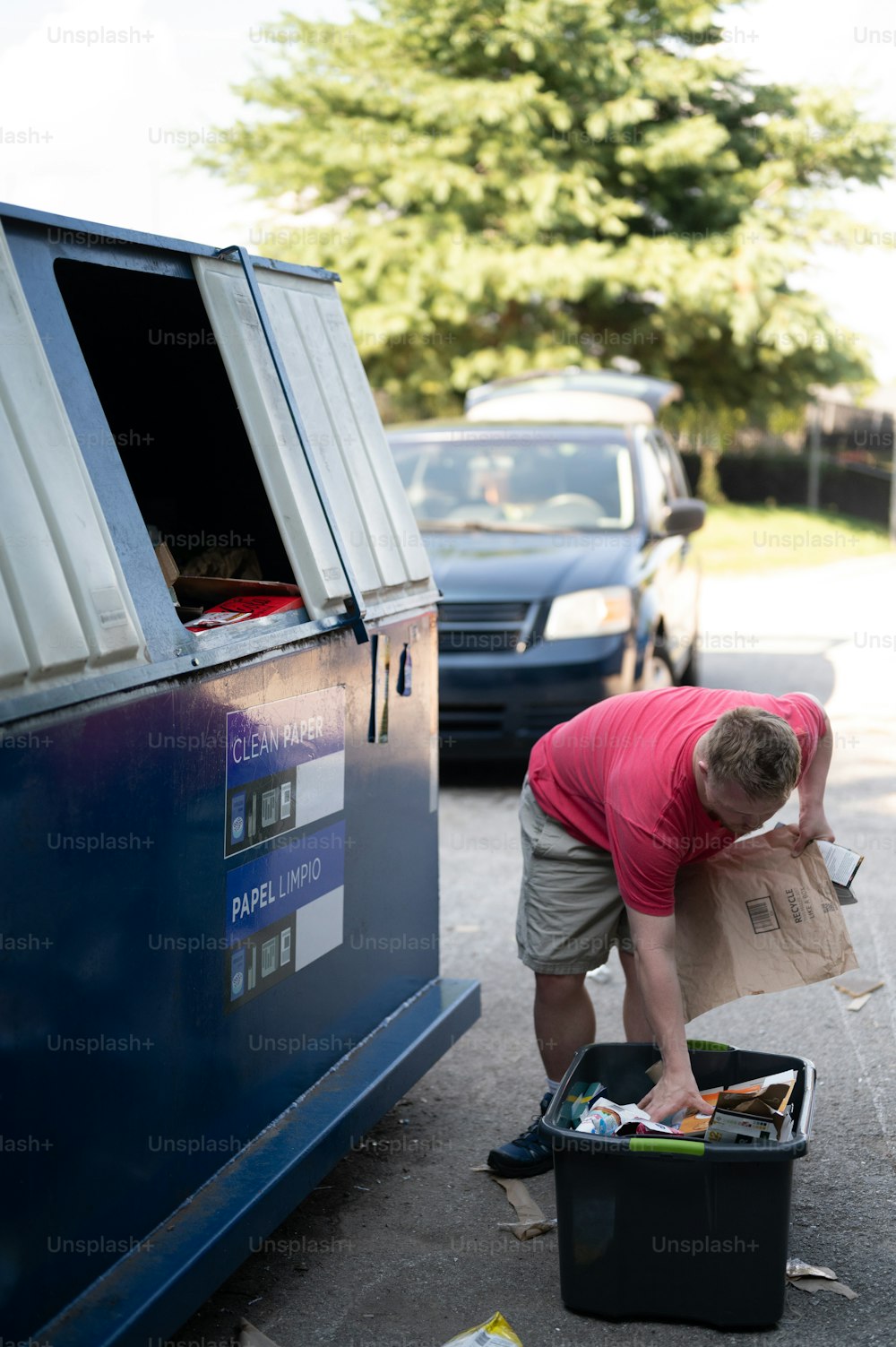 a man unloading a box of items from a van
