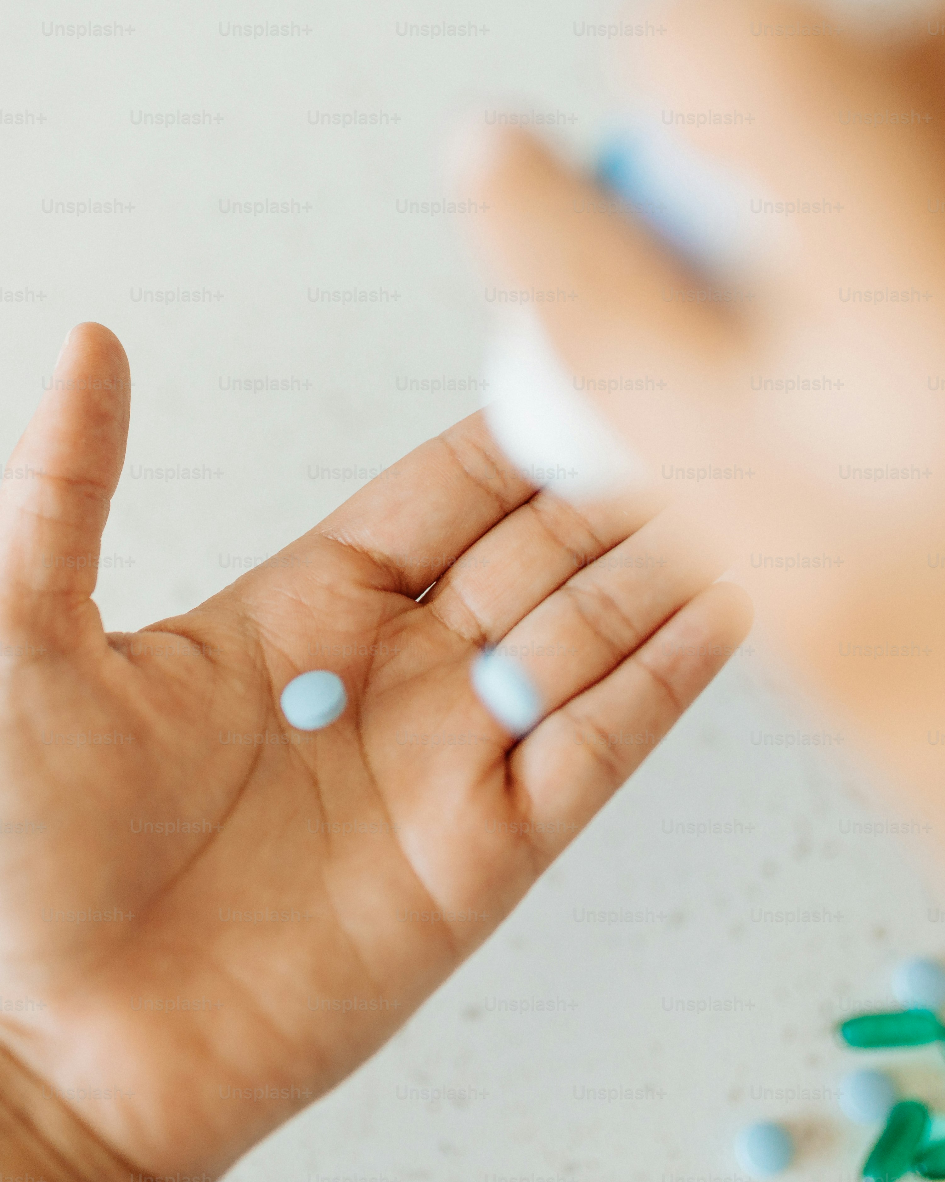 a person holding a pill in their hand