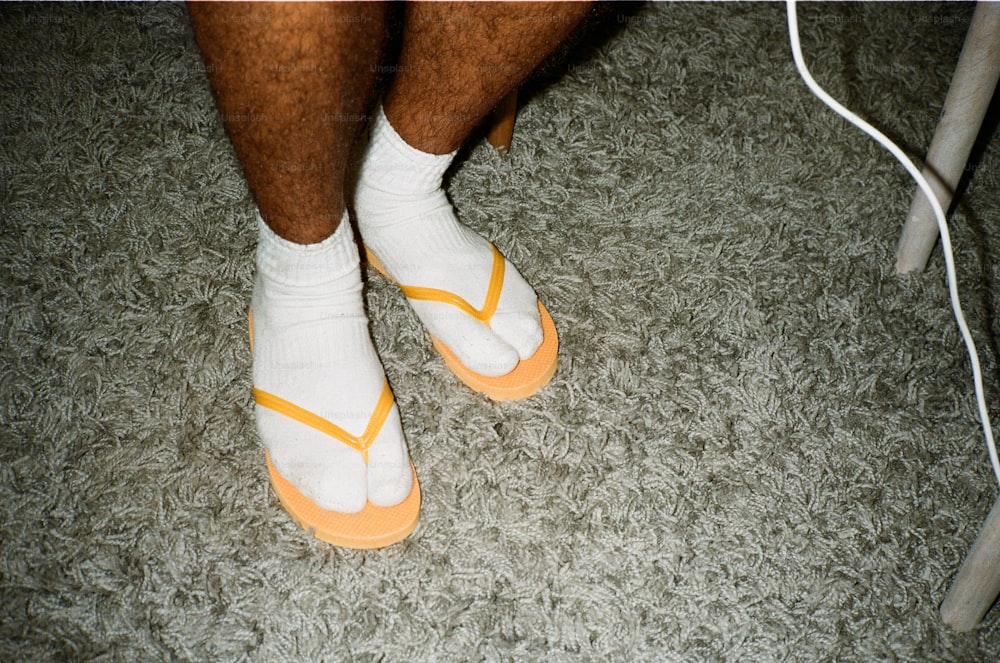 a close up of a person's feet wearing white socks