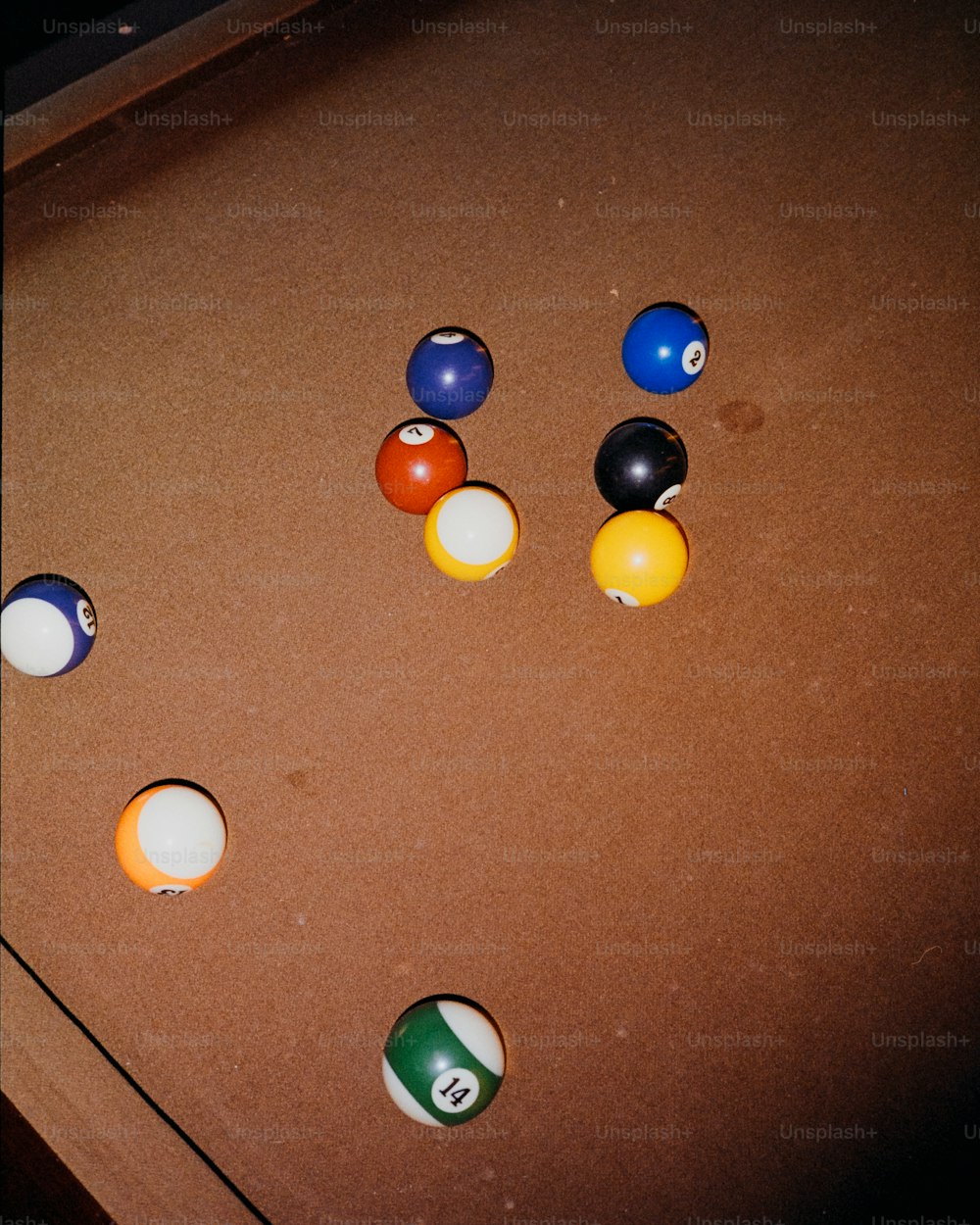 a pool table with several pool balls on it