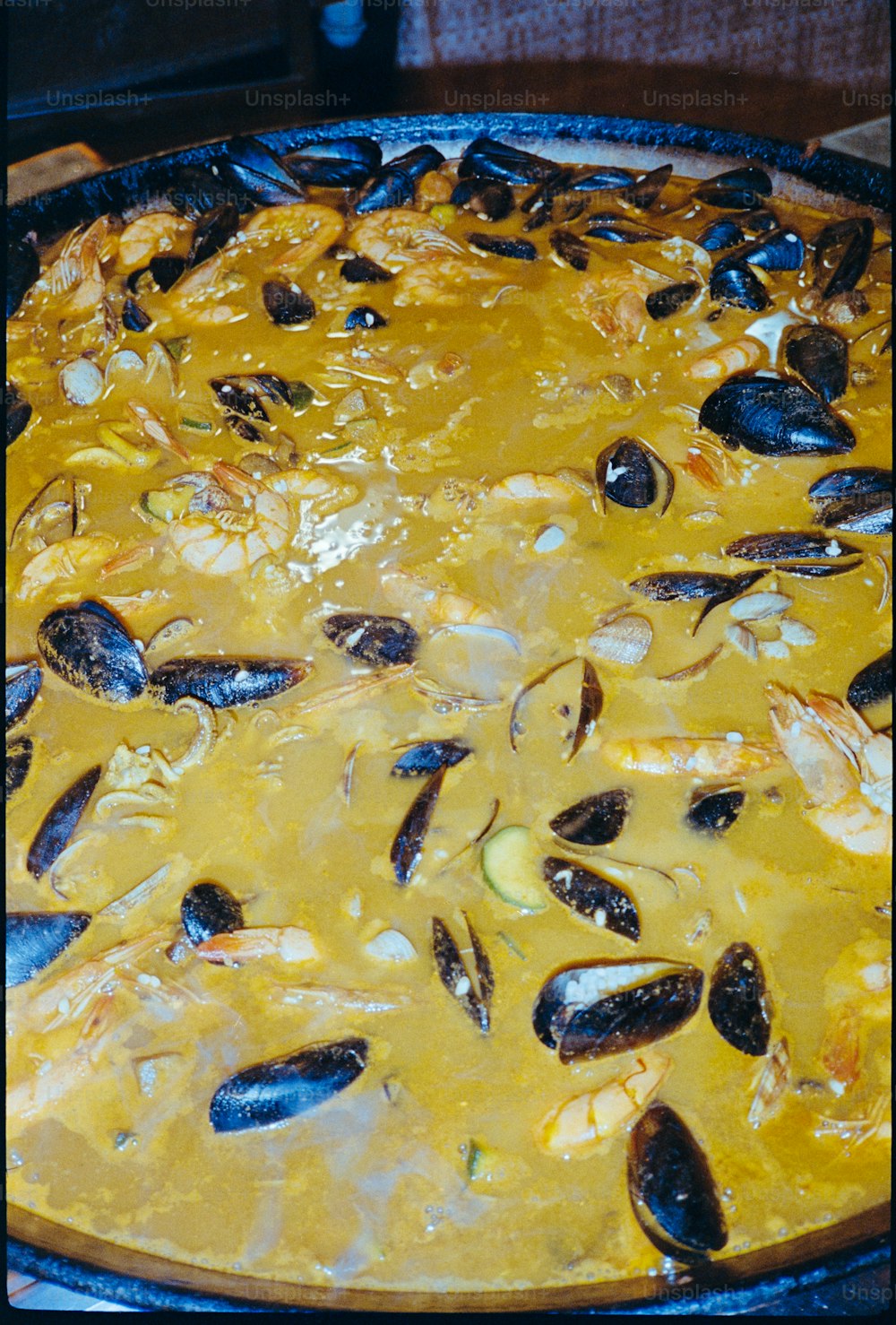 a dish of food with mussels and sauce