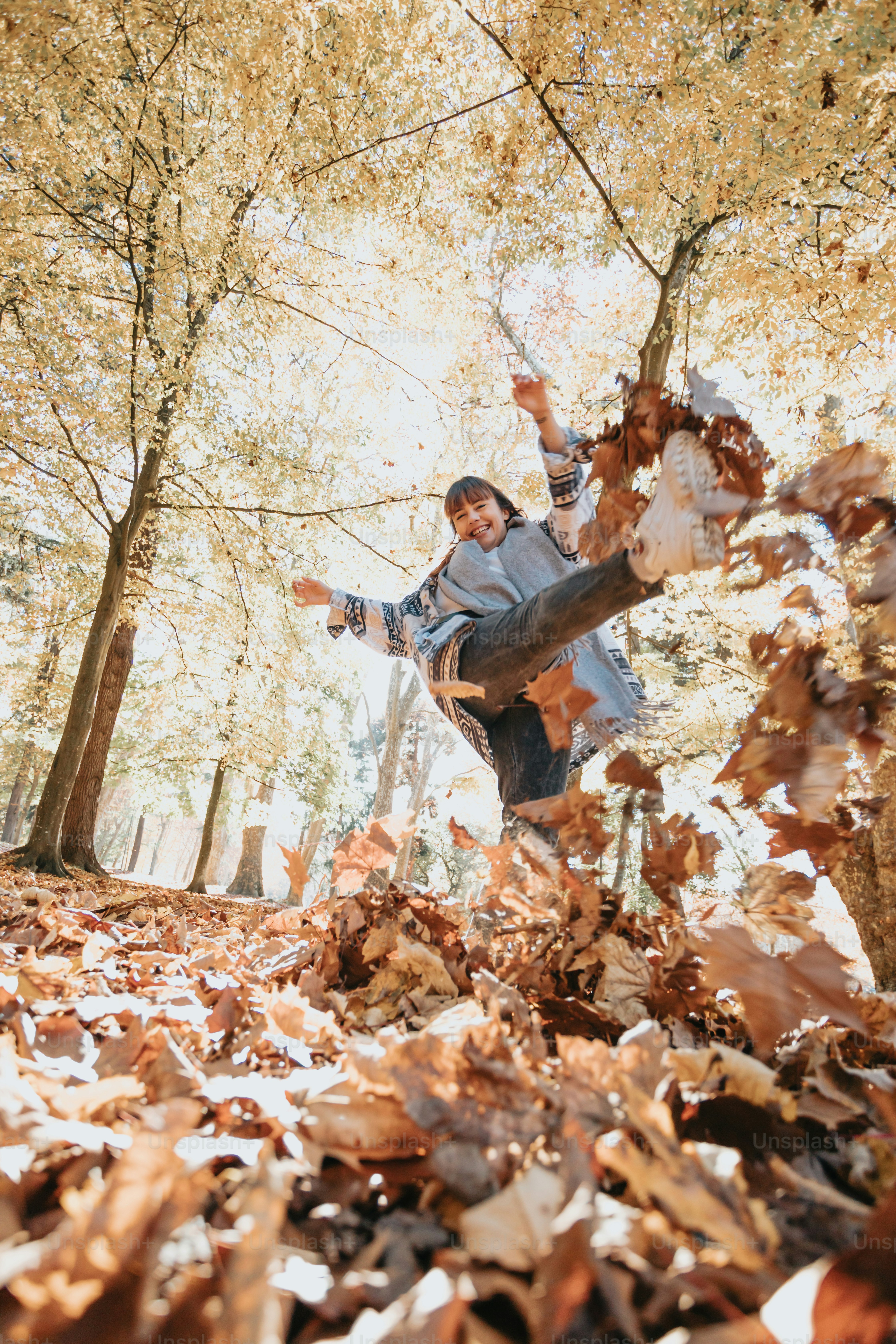 a man is throwing leaves in the air