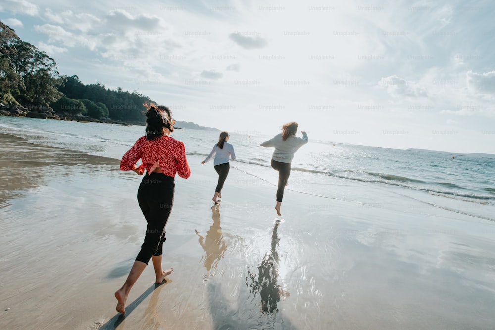 a group of people running along a beach