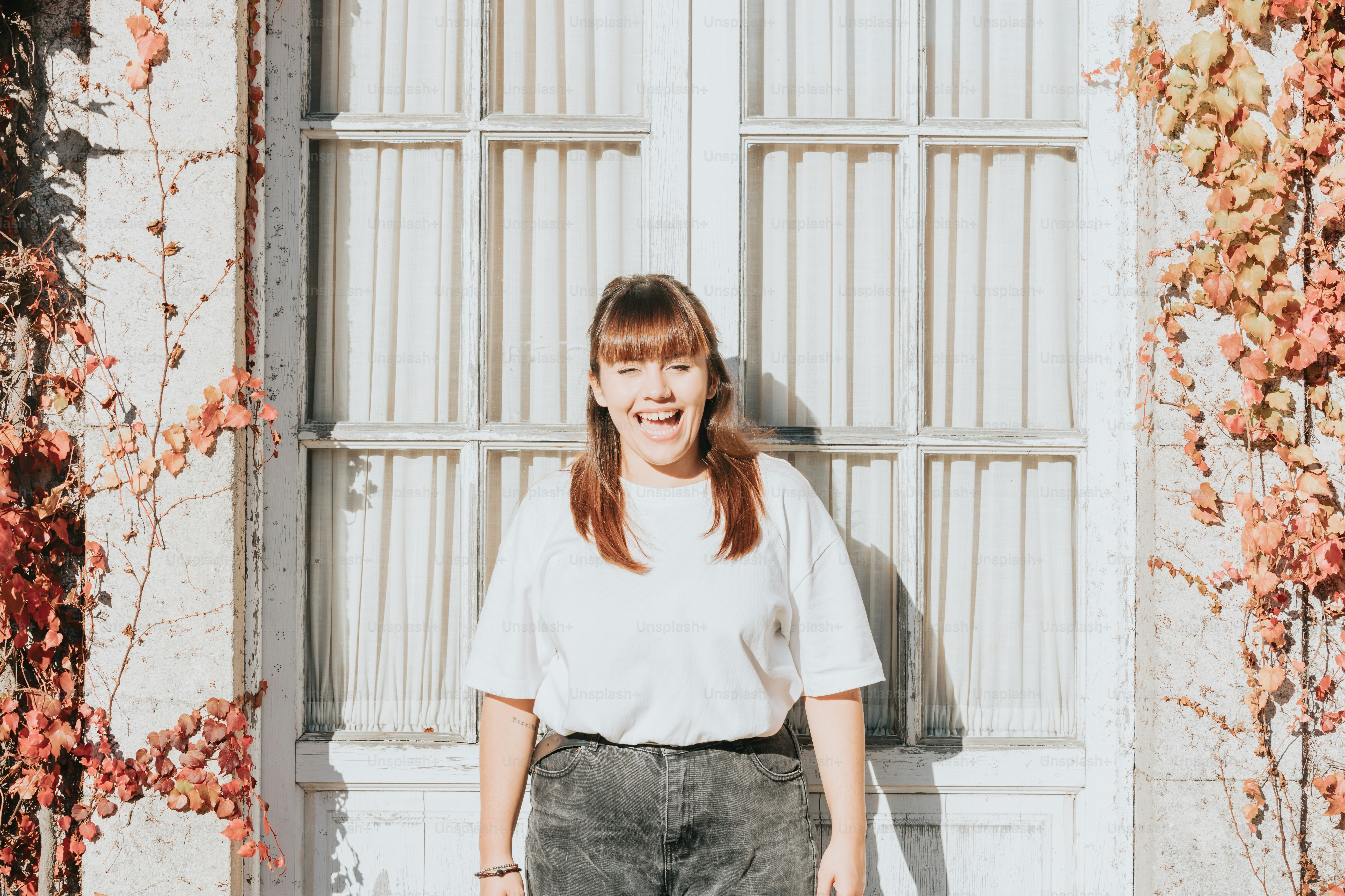 a woman standing in front of a window