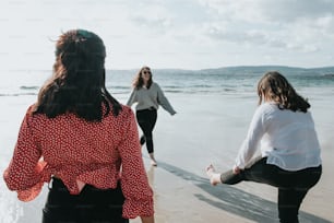 a group of women standing on top of a beach