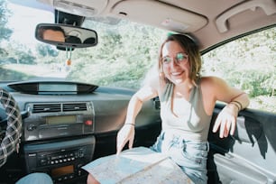 a woman sitting in the back seat of a car