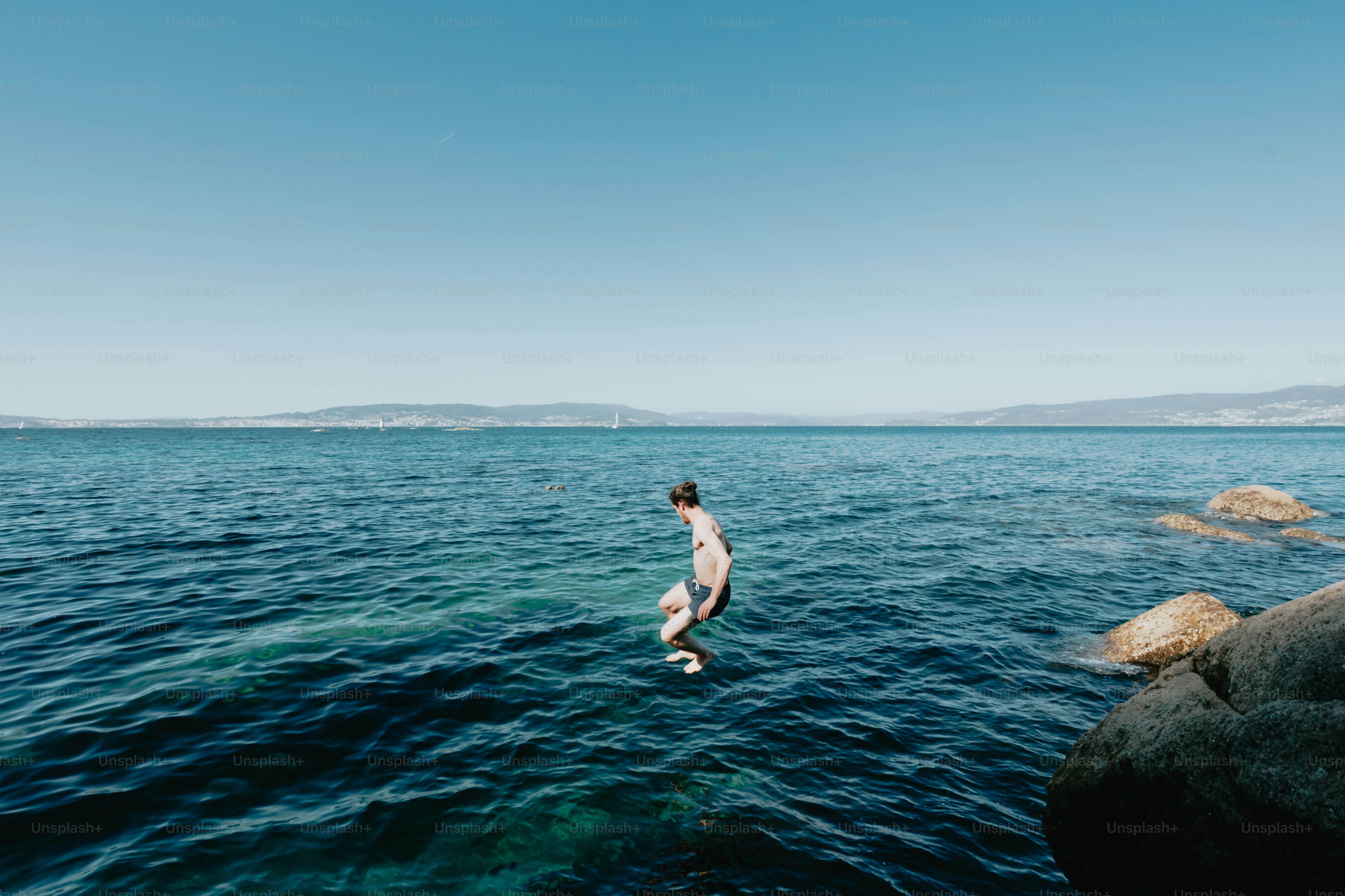a man standing on a surfboard in the middle of the ocean
