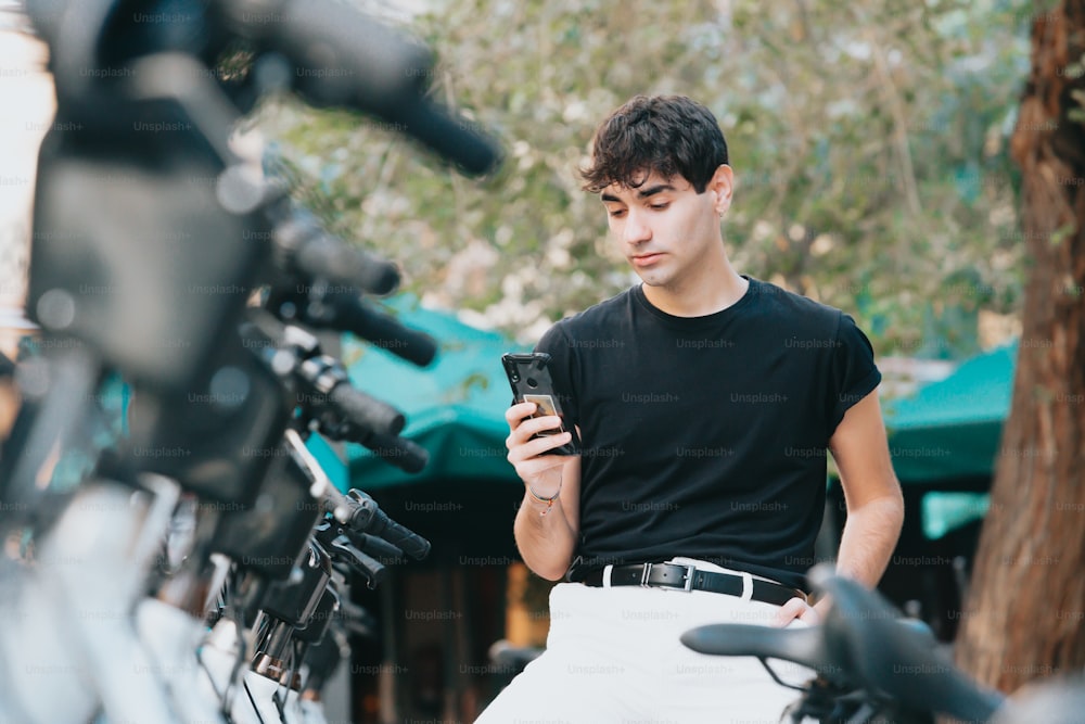 Un joven está mirando su teléfono celular