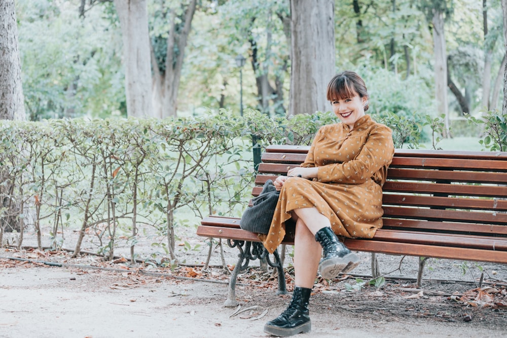 a woman sitting on a bench in a park