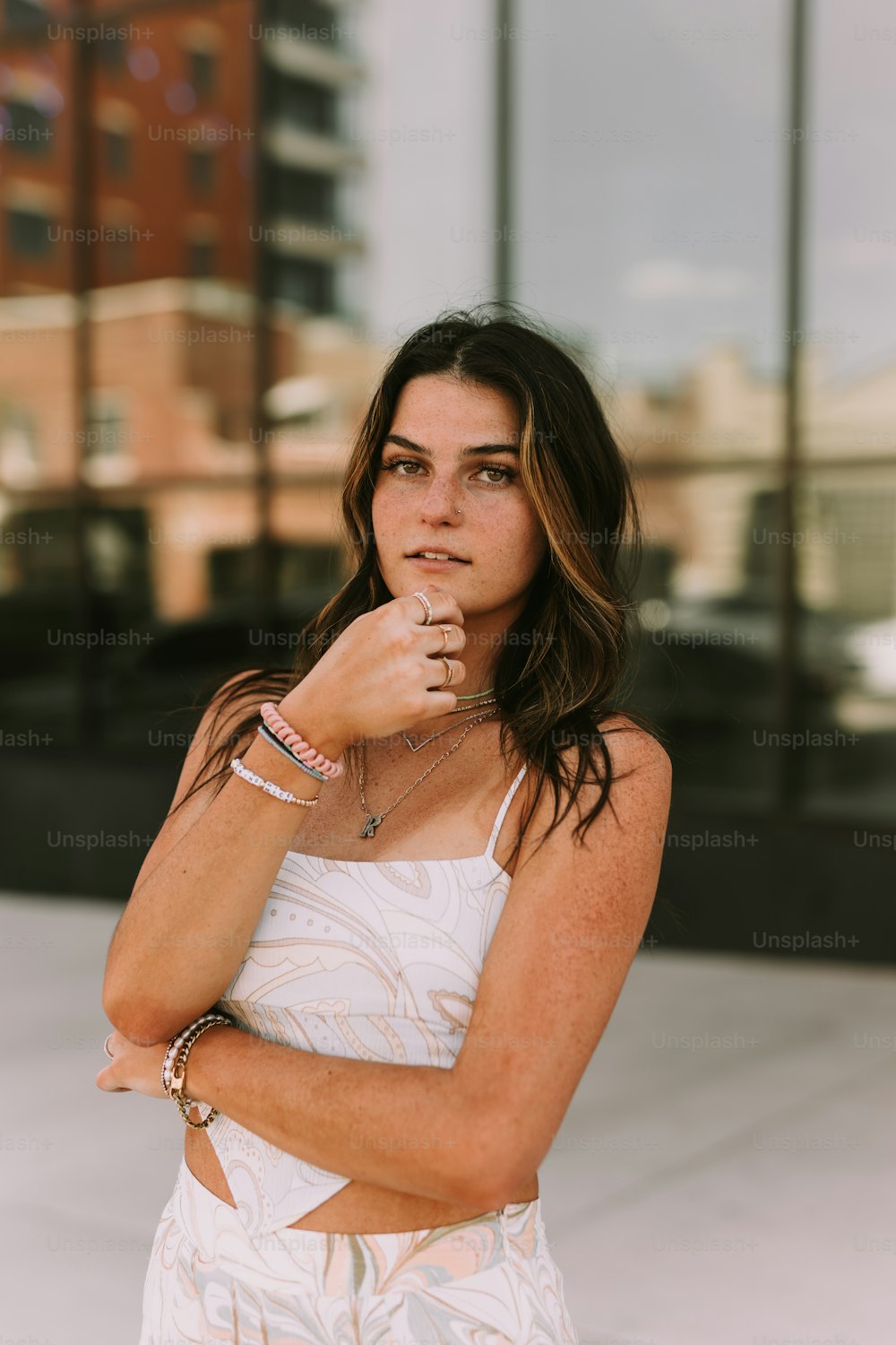 a woman in a white dress posing for a picture