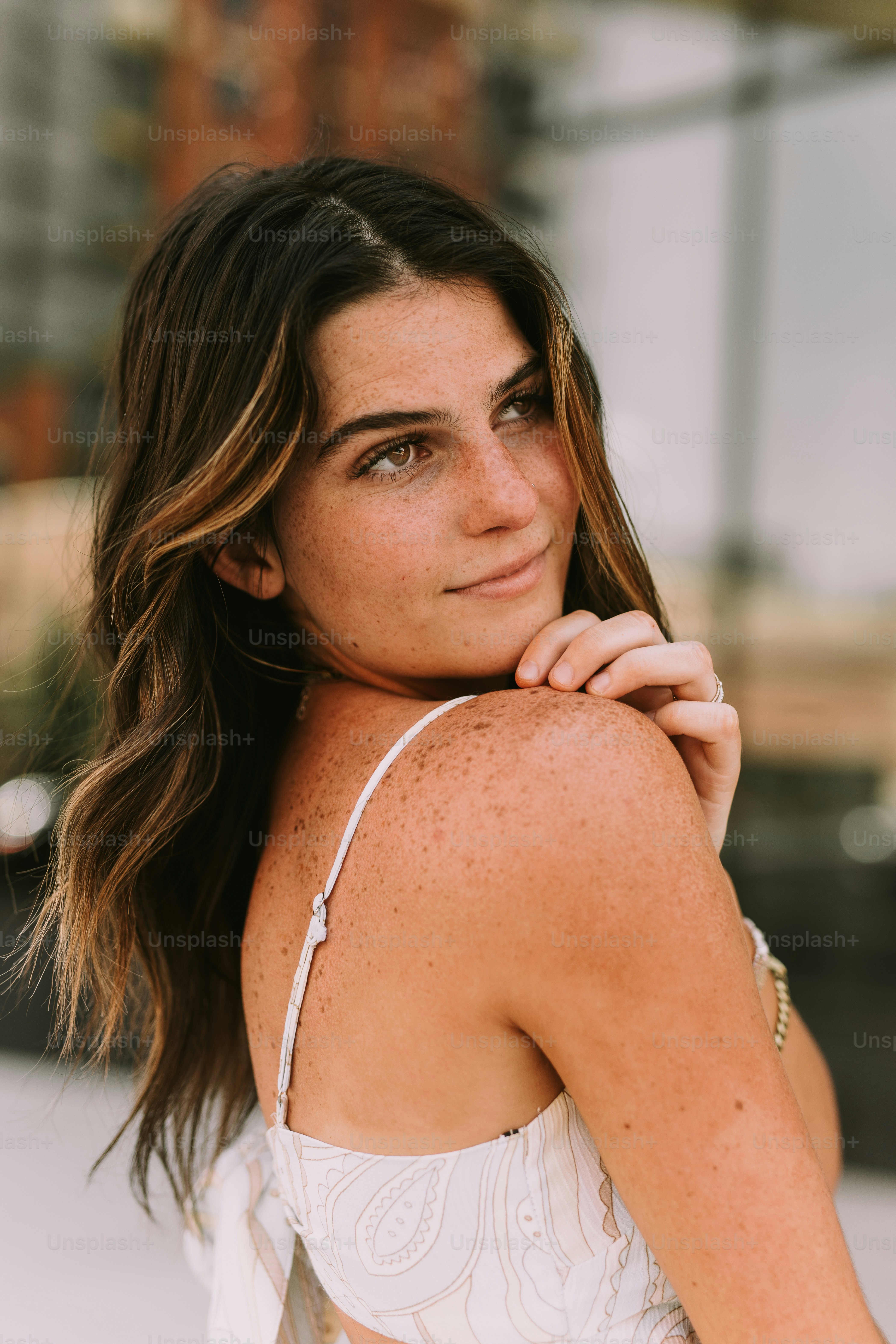 a woman in a white top posing for a picture