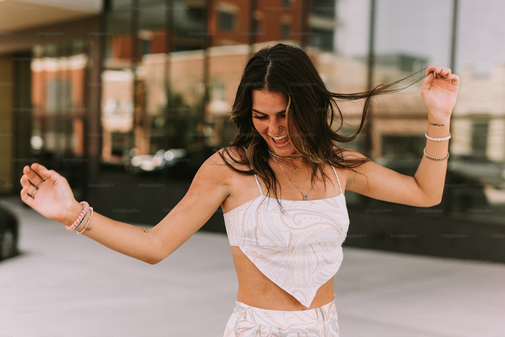 a woman in a white top is dancing
