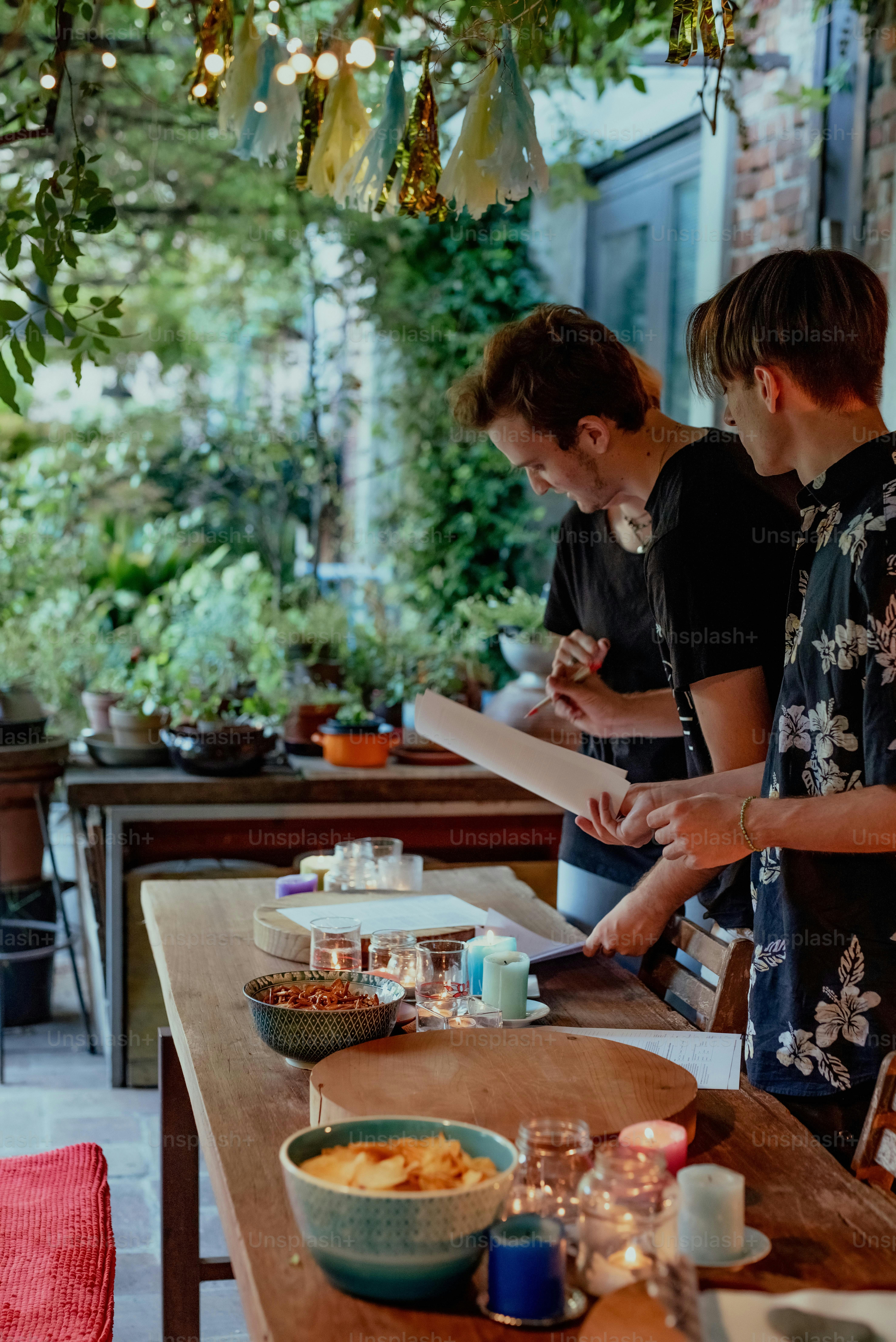 a group of people standing around a wooden table