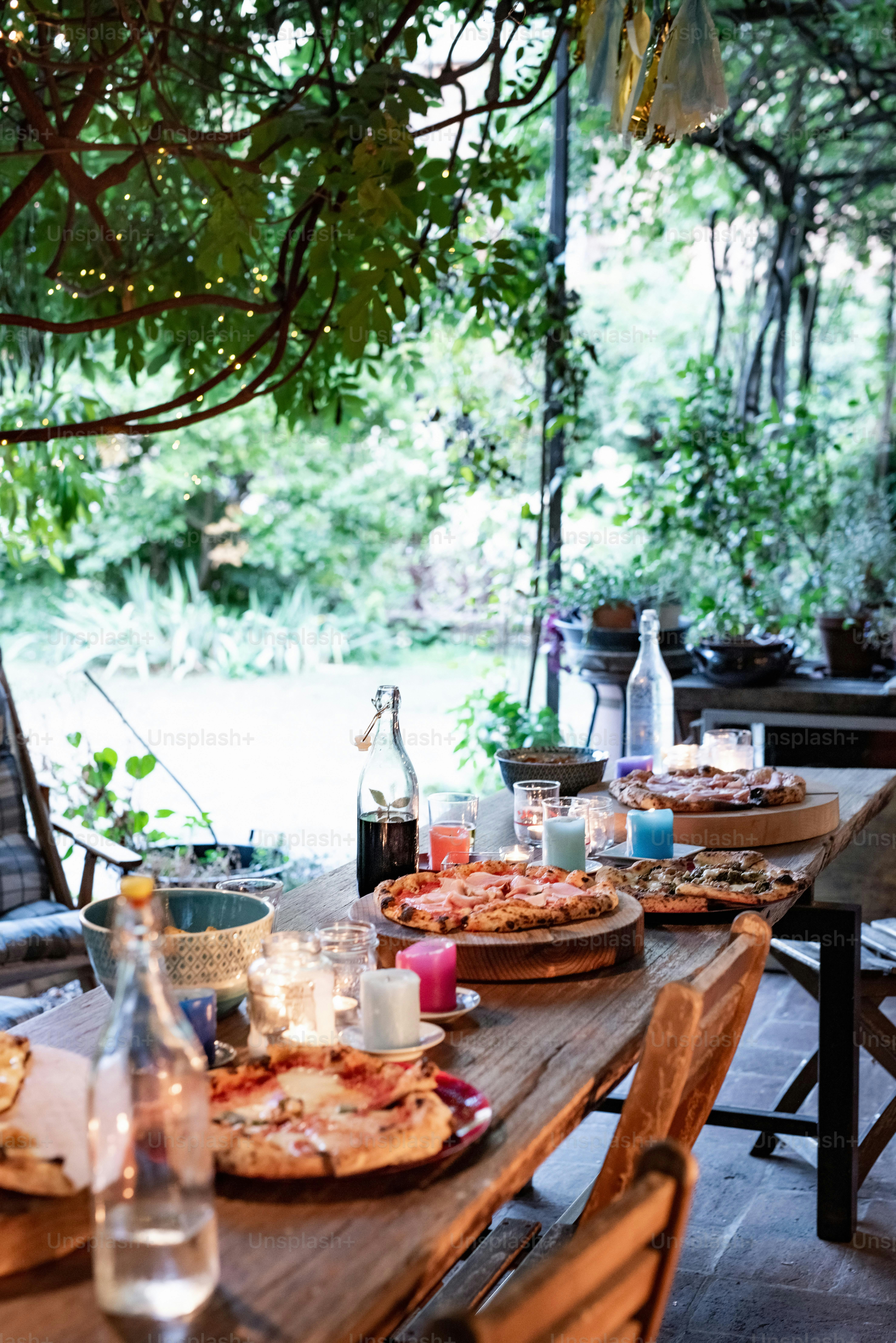 a wooden table topped with plates of food