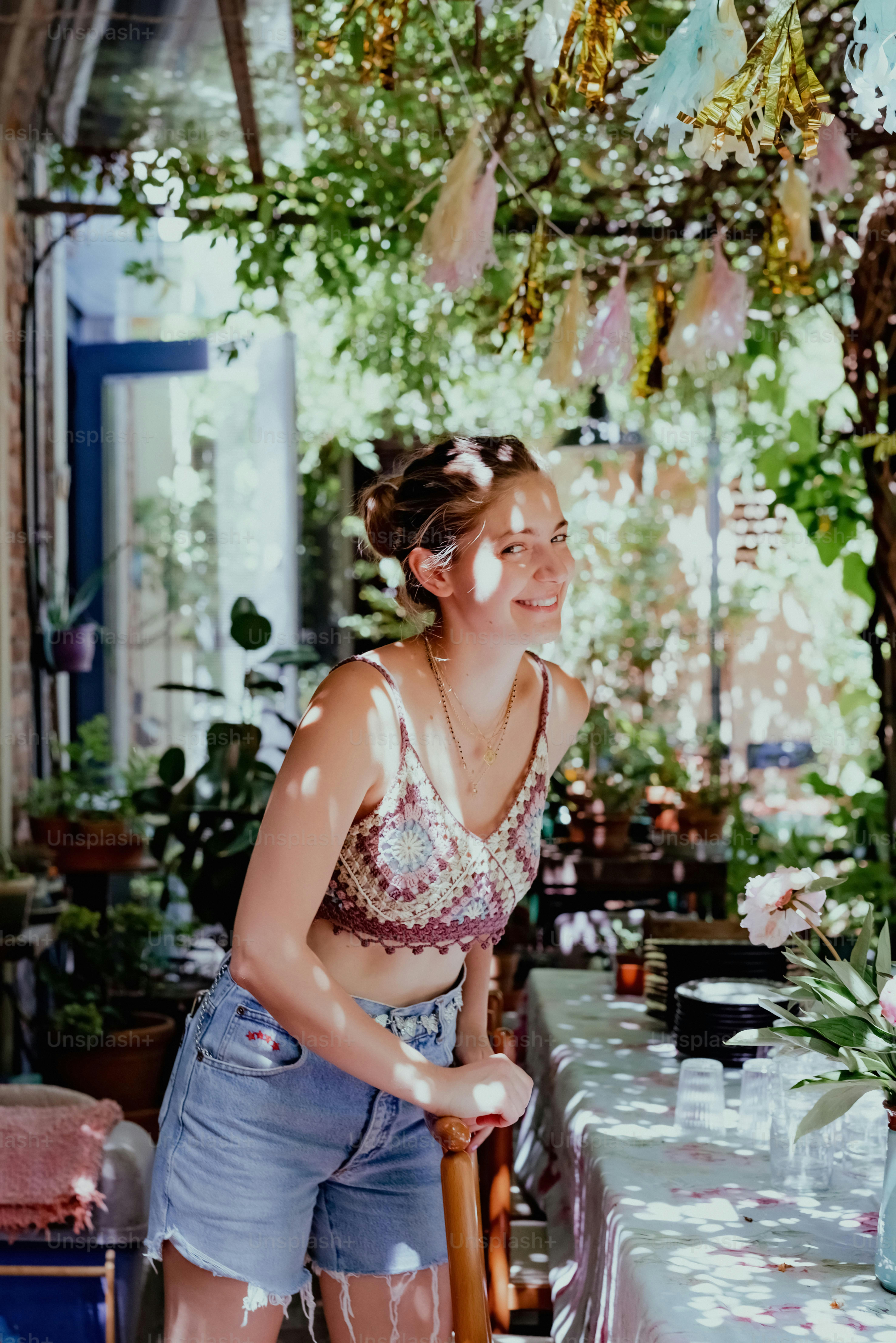 a woman standing in front of a table covered in flowers