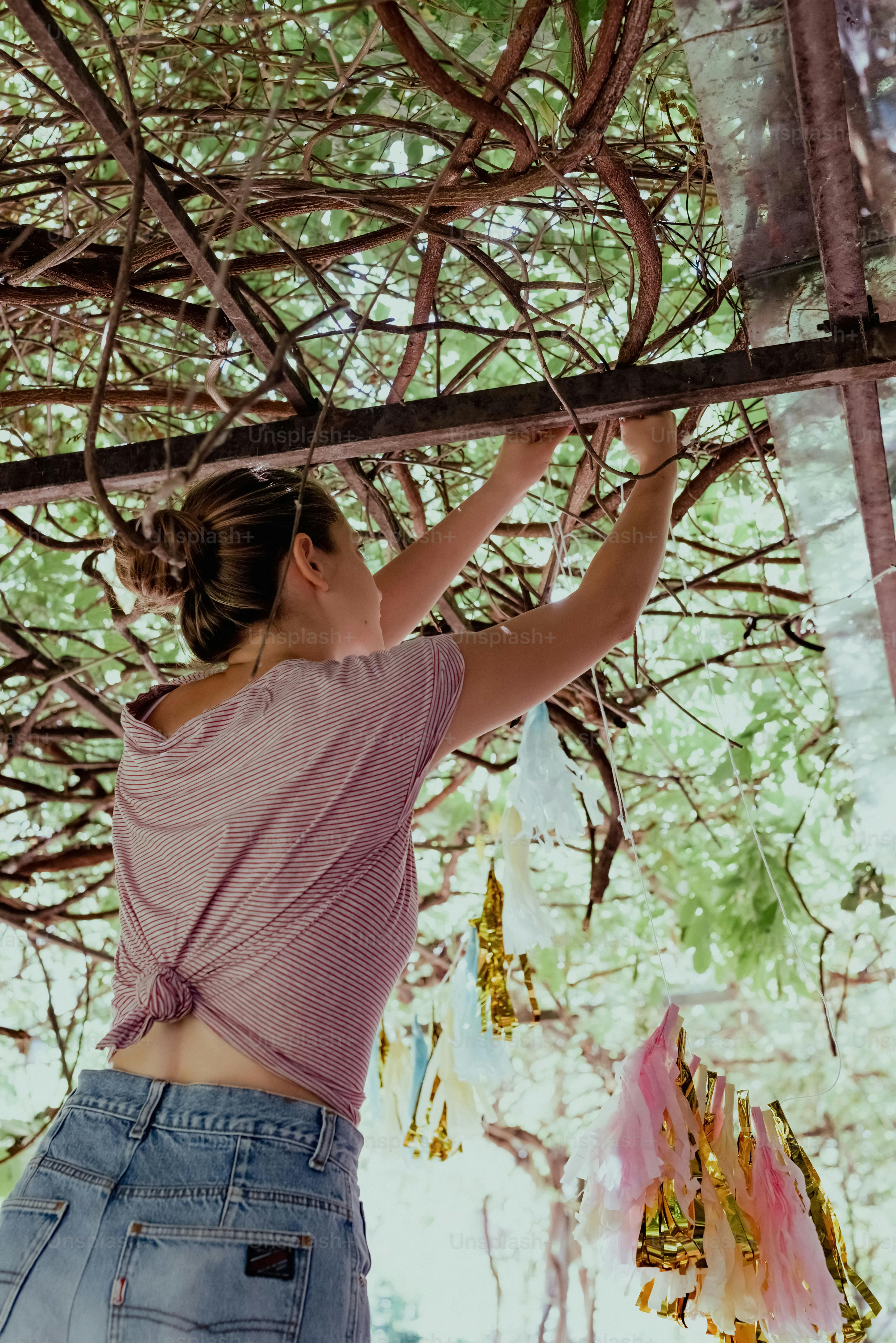 a woman in a pink shirt and blue jean shorts