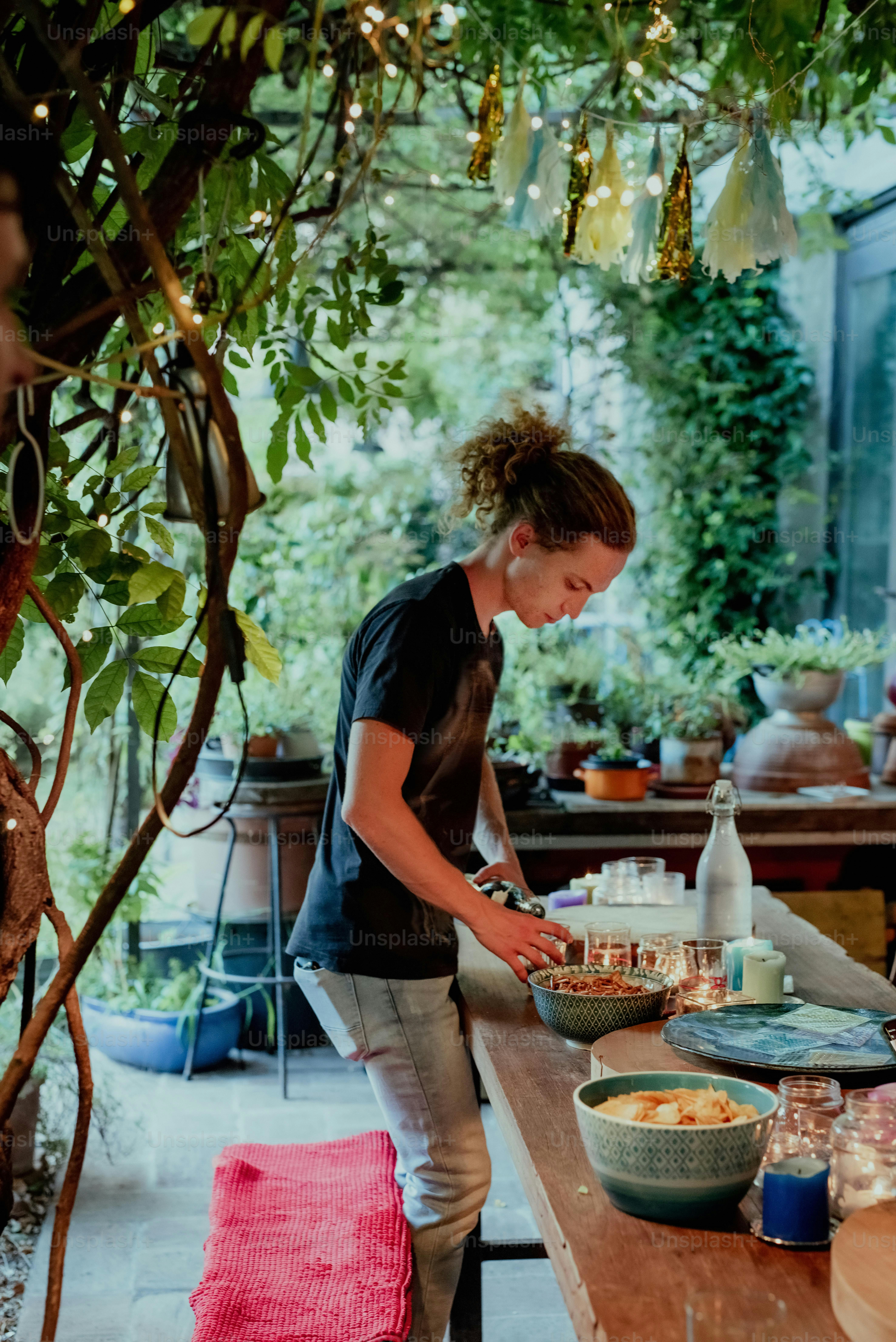 a woman preparing food on a wooden table