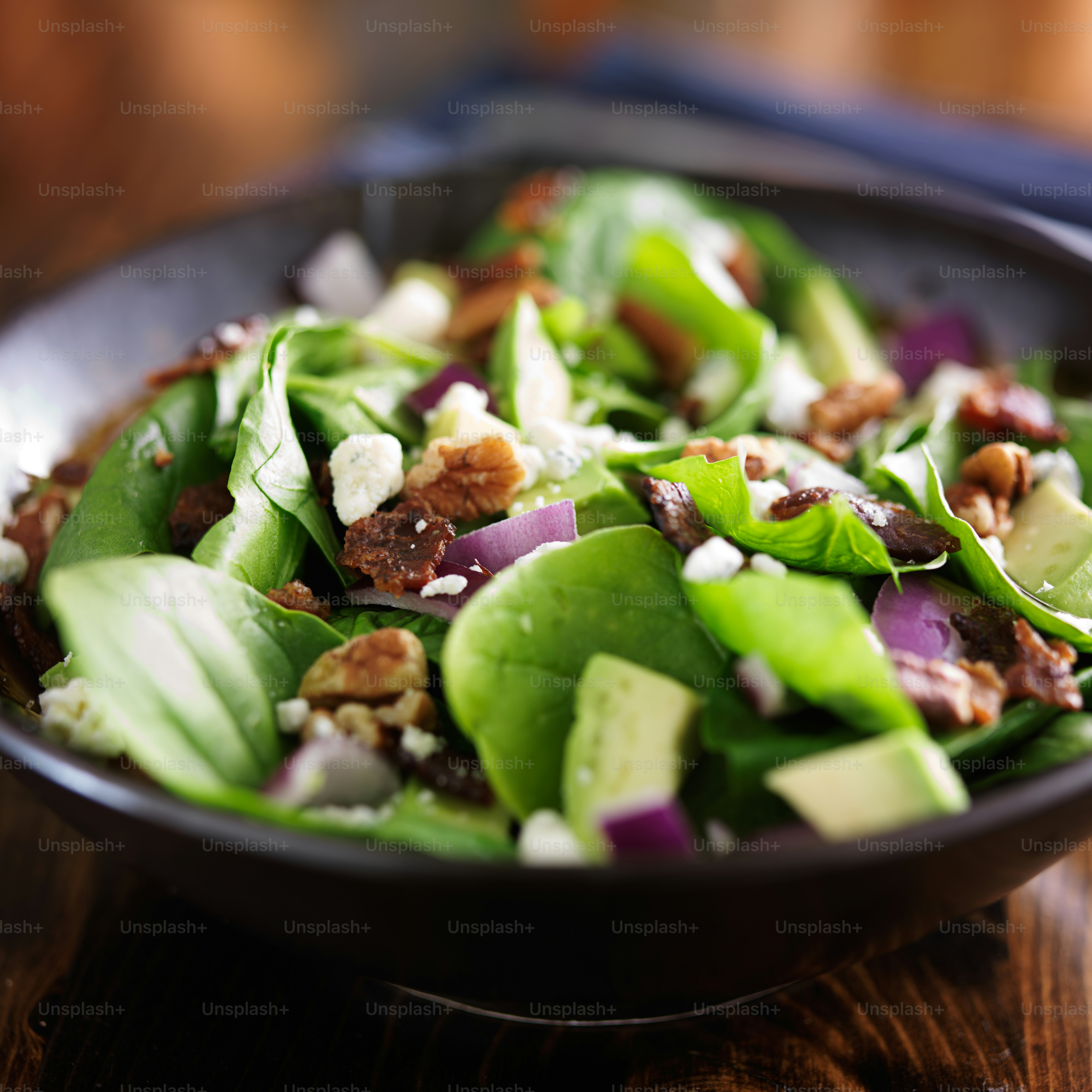 avocado spinach salad close up in bowl shot with selective focus