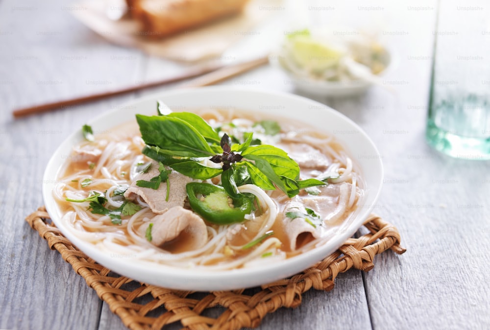 vietnamese pho soup dish with sliced beef and cilantro