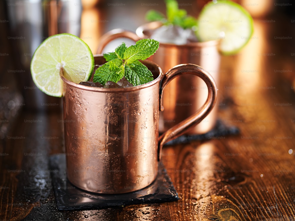 moscow mule cocktail in copper cup with mint and lime garnish