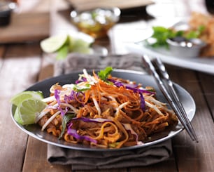 tasty pad thai stir fry with beef and colorful garnish shot with selective focus