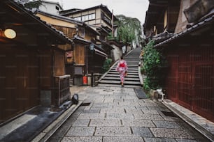 Kyoto, Japan Culture Travel - Asian traveler wearing traditional Japanese kimono walking in Higashiyama district in the old town of Kyoto, Japan.