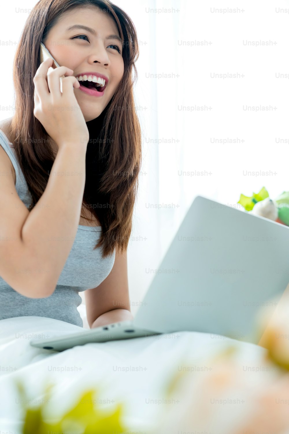 beautiful smiling asian woman enjoy happiness working at home successful positive thinking white bedroom background