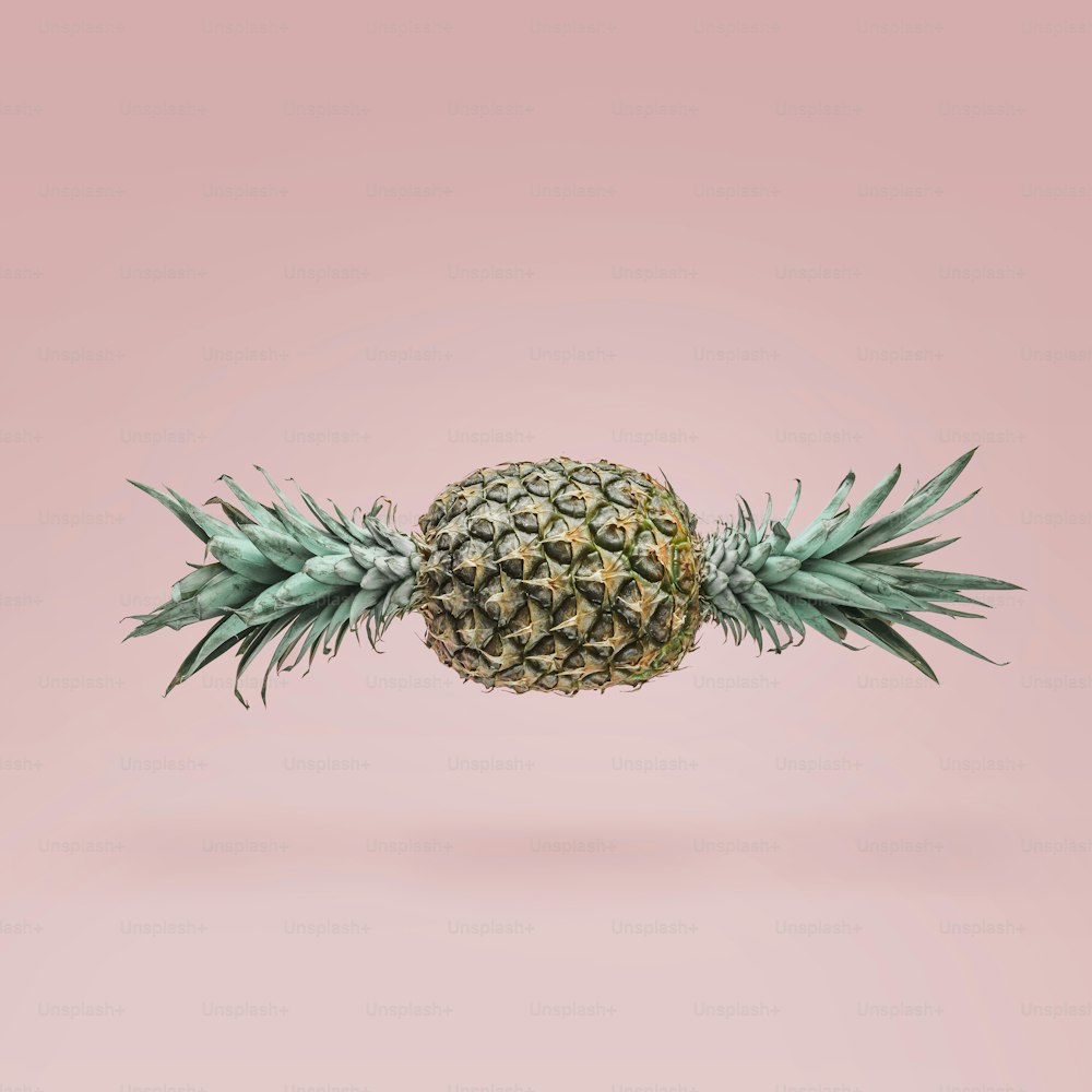 Candy made of ripe pineapple on pink background. Minimal candy concept.